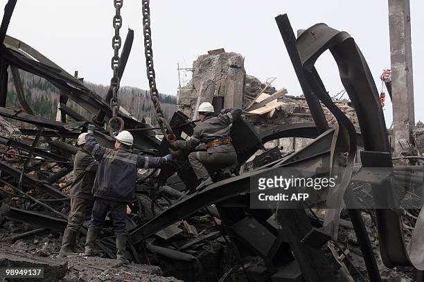 Workers remove debris at the site of an underground explosion, at the Raspadskaya mine in the city of Mezhdurechensk in the west Siberian region of...