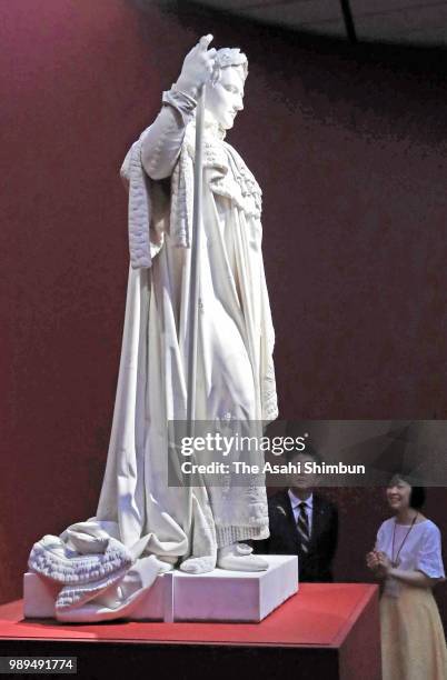 Japanese Prime Minister Shinzo Abe watches the 'Napoleon I in His Coronation Robes' during the 'Art of Portraiture in the Louvre Collections' at the...