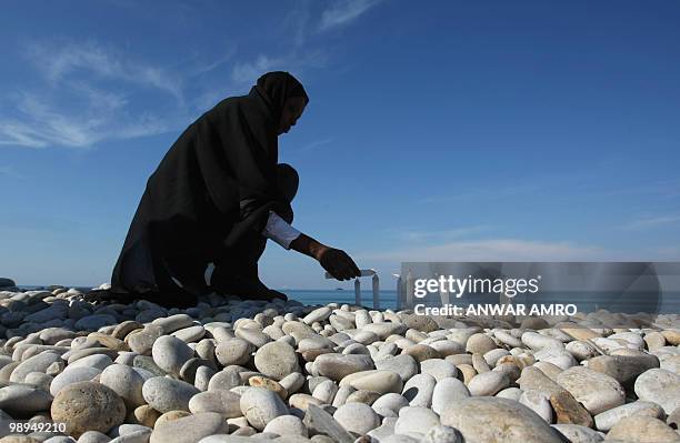 Ethiopian national Ana Gaitadagu lights candles for the victims of the Ethiopian plane off the shores of the town of Naameh, south of Beirut, on...