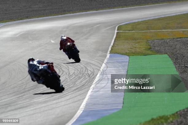 Casey Stoner of Australia and Ducati Marlboro Team leads Valentino Rossi of Italy and Fiat Yamaha Team and heads down a straight during the second...