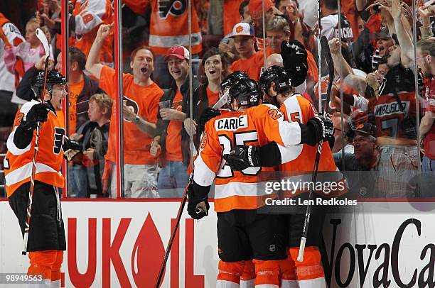 Braydon Coburn, Matt Carle and James van Riemsdyk of the Philadelphia Flyers celebrate with teammate Claude Giroux after Giroux scored a goal at 8:35...