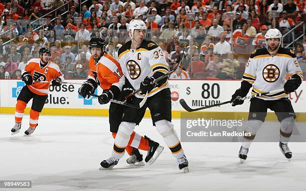 Simon Gagne and Mike Richards of the Philadelphia Flyers skates against Zdeno Chara and Johnny Boychuk of the Boston Bruins in Game Four of the...