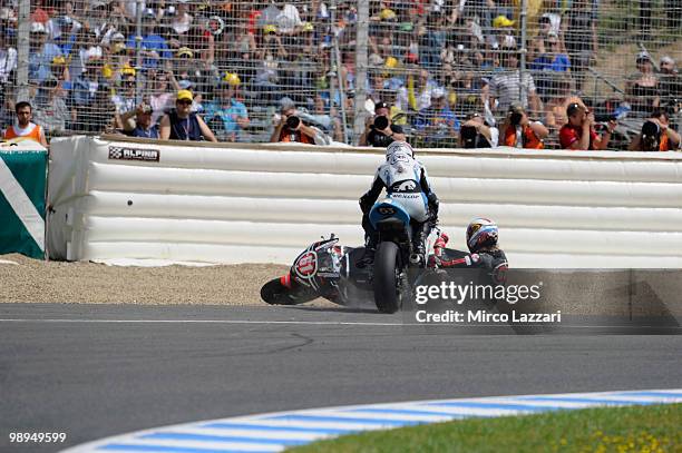 Vladimir Ivanov of Russia and Gresini Racing Moto2 and Valentin Debise of French and WTR San Marino Team crashed out during the Moto2 race at...