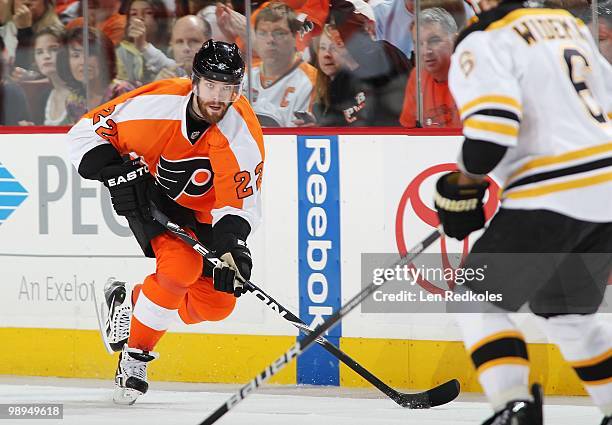 Ville Leino of the Philadelphia Flyers skates with the puck in on Dennis Wideman of the Boston Bruins in Game Four of the Eastern Conference...