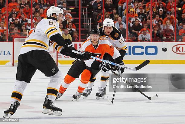 Claude Giroux of the Philadelphia Flyers skates after an air bourn puck against Miroslav Satan and Milan Lucic of the Boston Bruins in Game Four of...