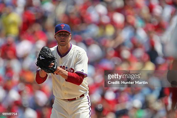 Starting pitcher Roy Halladay of the Philadelphia Phillies looks back a runner on third base during a game against the St. Louis Cardinals at...