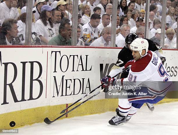 Scott Gomez of the Montreal Canadiens battles for a puck with Sidney Crosby of the Pittsburgh Penguins in Game Five of the Eastern Conference...