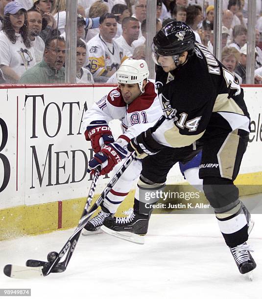 Scott Gomez of the Montreal Canadiens battles for a puck with Chris Kunitz of the Pittsburgh Penguins in Game Five of the Eastern Conference...