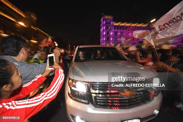 Supporters of the presidential candidate for the "Juntos haremos historia" coalition, Andres Manuel Lopez Obrador, cheer at his caravan at the Zocalo...