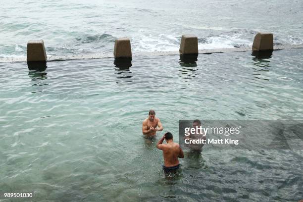 Jack de Belin, Latrell Mitchell and Tariq Sims swim during a New South Wales Blues State of Origin Recovery Session at Coogee Beach on July 2, 2018...