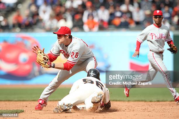 Andres Torres of the San Francisco Giants sliding into second while Chase Utley of the Philadelphia Phillies awaits the throw during the game = at...