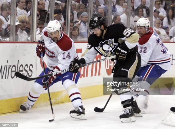 Tomas Plekanec of the Montreal Canadiens handles the puck in front of Kris Letang of the Pittsburgh Penguins in Game Five of the Eastern Conference...