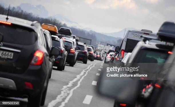 Rows of cars move slowly ahead on the A8 motorway near Holzkirchen, Germany, 23 December 2017. Holiday traffic is jamming the streets across Bavaria...