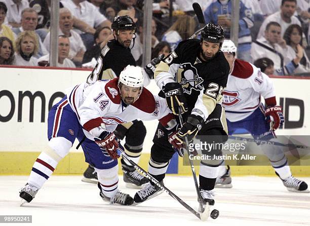 Maxime Talbot of the Pittsburgh Penguins battles for a puck with Tomas Plekanec of the Montreal Canadiens in Game Five of the Eastern Conference...
