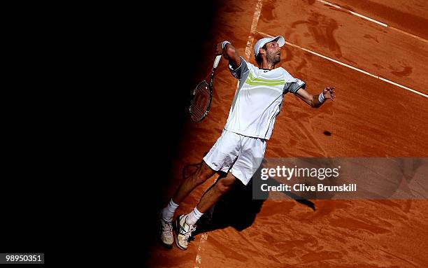 Stephane Robert of France serves against Gael Monfils of France in their first round match during the Mutua Madrilena Madrid Open tennis tournament...
