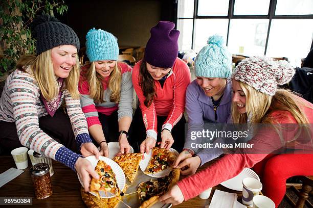 girls sharing pizza. - ski resort stock pictures, royalty-free photos & images