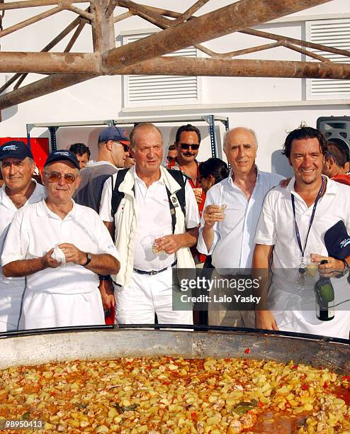 King Juan Carlos of Spain poses in front of a giant paella prepared to celebrate the completion of the "Copa del Rey" Sailing Trophy in Mallorca