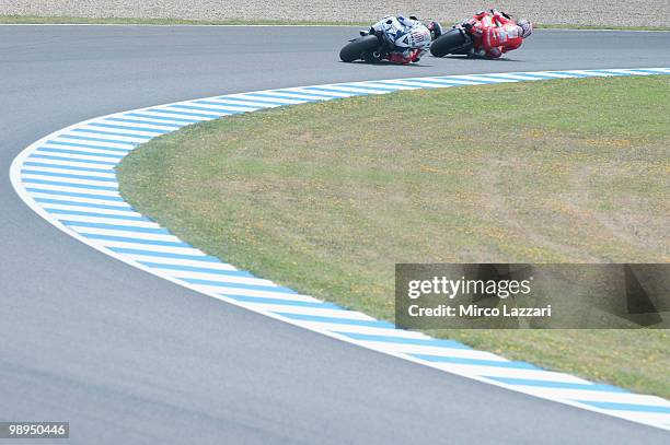 Casey Stoner of Australia and Ducati Marlboro Team leads Jorge Lorenzo of Spain and Fiat Yamaha Team during the MotoGP race at Circuito de Jerez on...