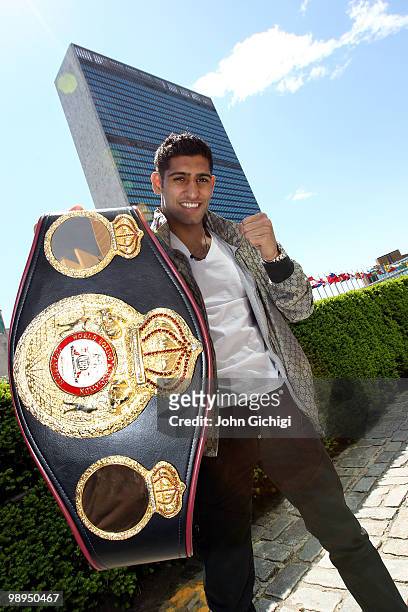 British boxer Amir Khan poses with the WBA World light welterweight championship belt in front of the United Nations Headquarters on May 10, 2010 in...