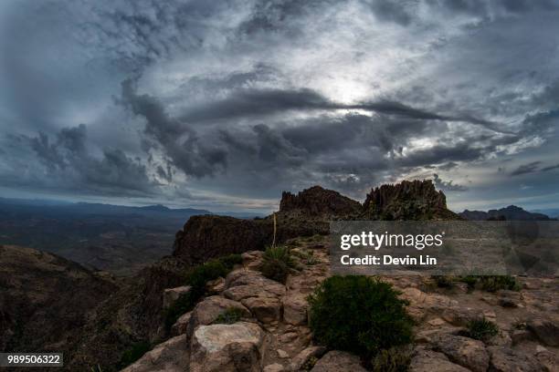 dramatic sky over rocky landscape, arizona, usa - devin bush stock pictures, royalty-free photos & images