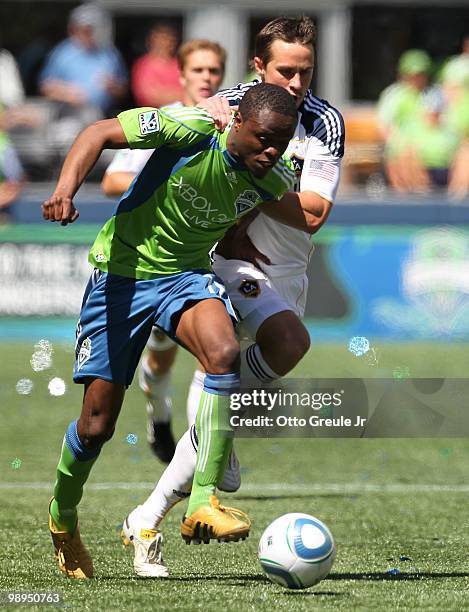 Steve Zakuani of the Seattle Sounders FC dribbles against Todd Dunivant of the Los Angeles Galaxy on May 8, 2010 at Qwest Field in Seattle,...