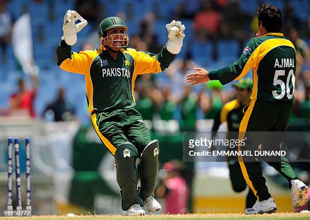 Pakistani wicketkeeper Kamran Akmal and bowler Saeed Ajmal celebrate after stumping South African batsman Johan Botha during the ICC World Twenty20...