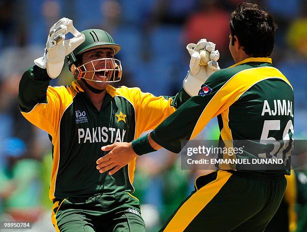 Pakistani wicketkeeper Kamran Akmal and bowler Saeed Ajmal celebrate after stumping South African batsman Johan Botha during the ICC World Twenty20...