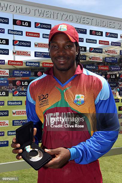 Chris Gayle of West Indies poses with his man of the match award after the ICC World Twenty20 Super Eight match between Sri Lanka and Australia at...