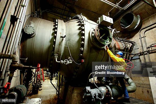 Gale Higgins, superintendent of hydro assets power generation for the Sacramento Municipal Utility District , cleans oil off a turbine shut-off valve...