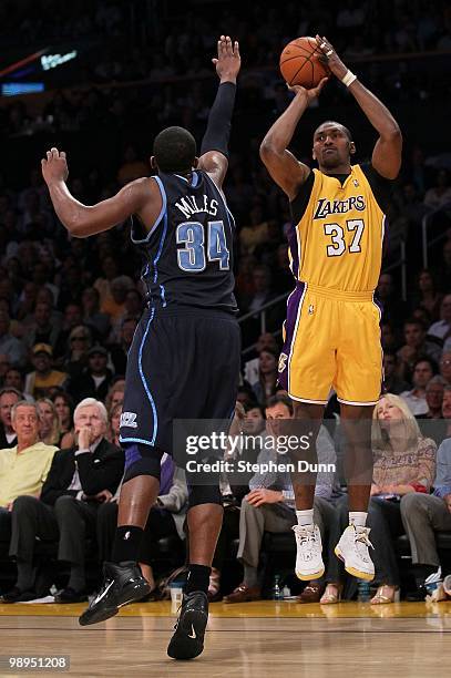 Ron Artest of the Los Angeles Lakers shoots a three-pointer over C.J. Miles of the Utah Jazz during Game Two of the Western Conference Semifinals of...
