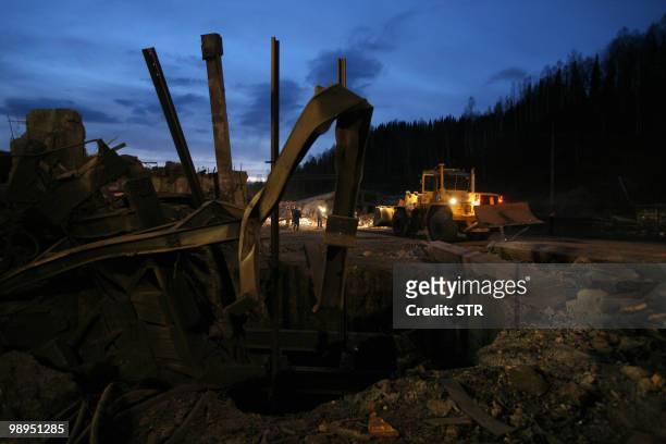 Workers remove debris at the site of an underground explosion, at the Raspadskaya mine in the city of Mezhdurechensk in the west Siberian region of...
