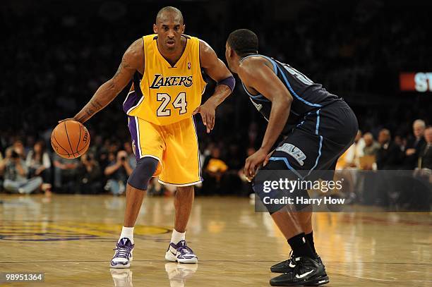 Kobe Bryant of the Los Angeles Lakers drives on C.J. Miles of the Utah Jazz in the first quarter during Game Two of the Western Conference Semifinals...