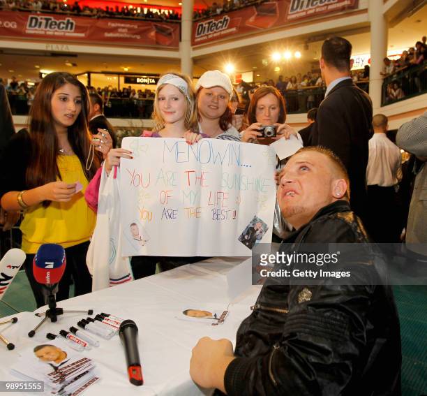 Menowin Froehlich signs autographs for fans during a visit at Lugner City on May 10, 2010 in Vienna, Austria.
