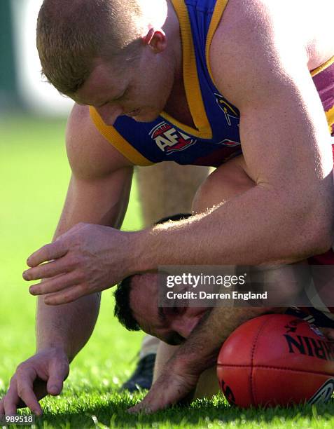 Michael Voss of Brisbane tackles Tony Liberatore of the Bulldogs during the round 18 AFL match between the Brisbane Lions and the Western Bulldogs...