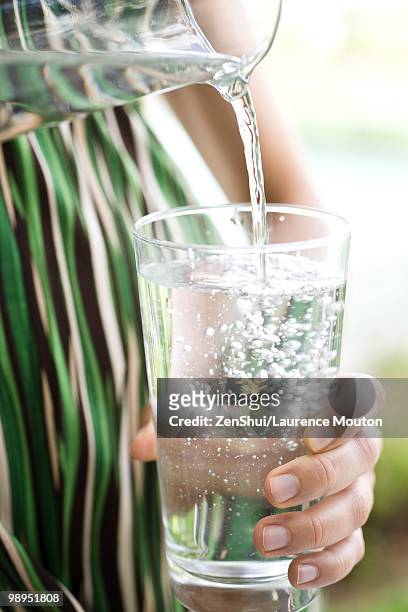 pouring glass of water - drinking water glass woman stock-fotos und bilder