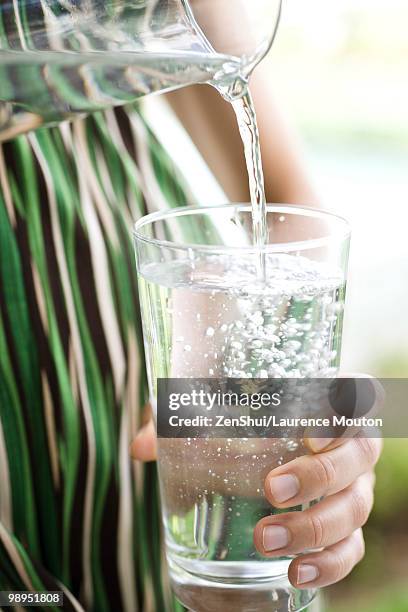 pouring glass of water - jug stock pictures, royalty-free photos & images