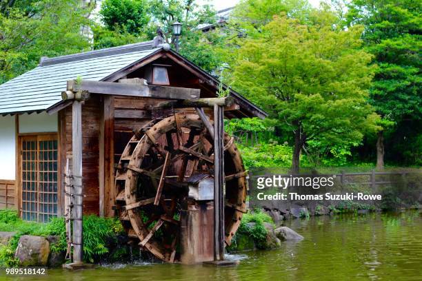 watermill at shoto park - wasserrad stock-fotos und bilder