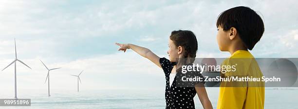 children pointing to wind turbines in distance - girl panoramic stock pictures, royalty-free photos & images