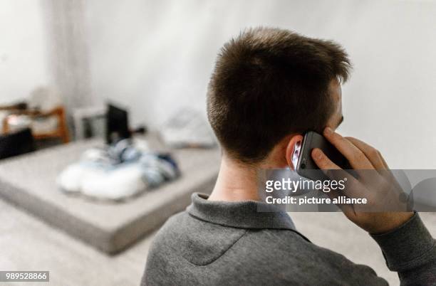 Man calls a counselling service on his mobile phone in Hamburg, Germany, 23 December 2017. Many people are anything but happy during the Christmas...