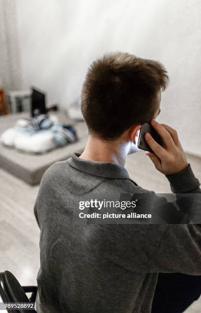 Man calls a counselling service on his mobile phone in Hamburg, Germany, 23 December 2017. Many people are anything but happy during the Christmas...