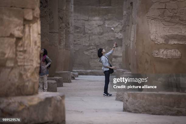 Picture issued on 24 December 2017, shows tourists taking pictures of the hall of columns at the Karnak Temple, in Luxor, Upper Egypt, 08 December...