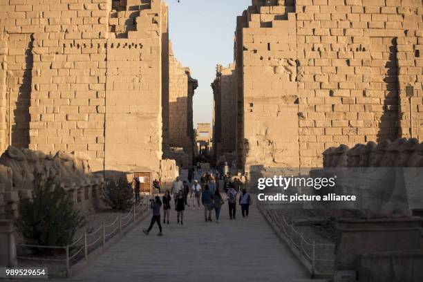 Picture issued on 24 December 2017, shows tourists walk at the Alley of Sphinxes, known as the "Kebash Road", at the Karnak Temple, in Luxor, Upper...