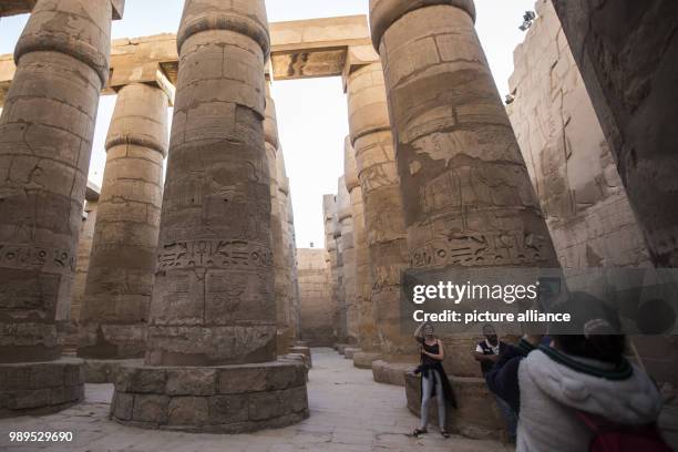 Picture issued on 24 December 2017, shows tourists taking pictures of the hall of columns at the Karnak Temple, in Luxor, Upper Egypt, 08 December...