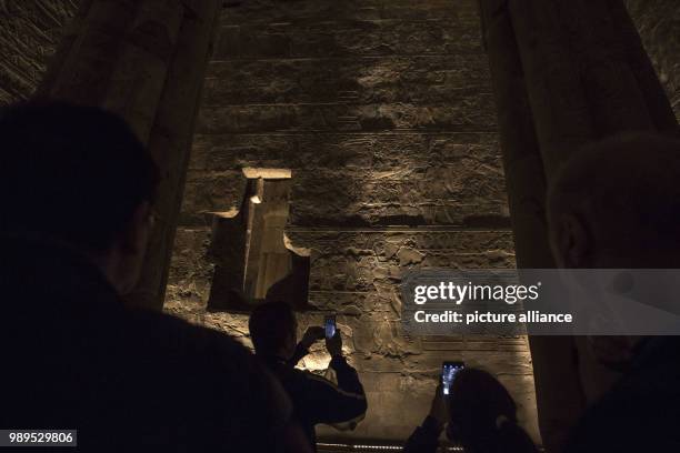 Picture issued on 24 December 2017, shows tourists taking photos during a light show at the Luxor Temple in Luxor, Upper Egypt, 10 December 2017....