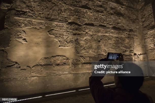 Picture issued on 24 December 2017, shows a tourist taking photos during a light show at the Luxor Temple in Luxor, Upper Egypt, 10 December 2017....