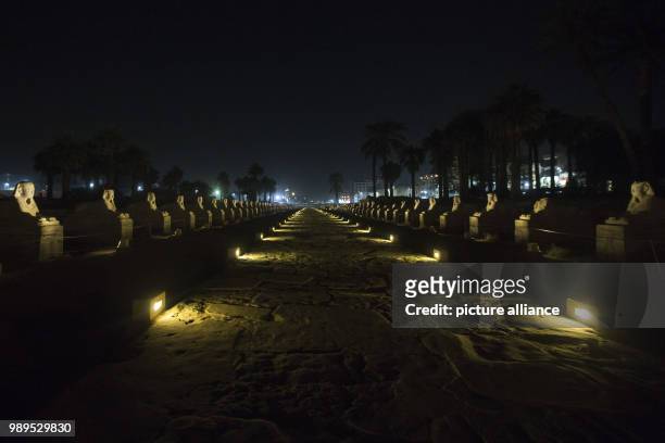 Picture issued on 24 December 2017, shows the Alley of Sphinxes, also known as Kebash road, illuminated during a light show at the Luxor Temple in...