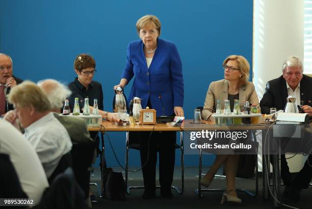 German Chancellor and leader of the German Chistian Democrats Angela Merkel pours coffee as she for an early morning meeting of the CDU governing...