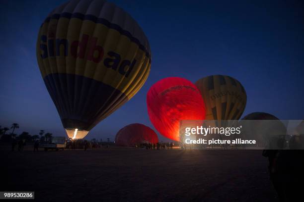 Picture made available on 25 December 2017, shows hot air balloons being prepared to take off during early morning hours in Luxor, Upper Egypt, 09...