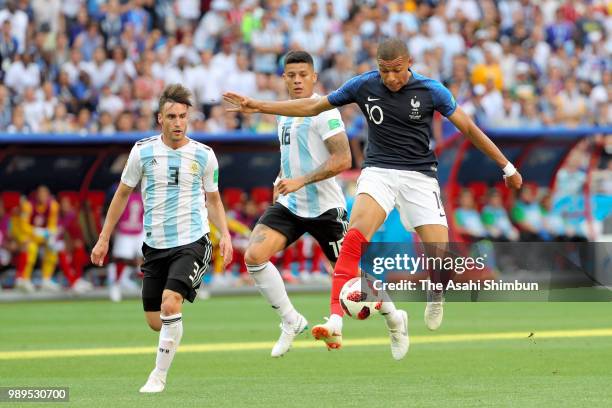 Kylian Mbappe of France controls the ball under pressure of Nicolas Tagliafico and Marcos Rojo of Argentina during the 2018 FIFA World Cup Russia...