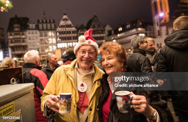 Thousands of people, including Werner and Sissy , gather on the Roemerberg to listen to the traditional "Grosses Stadtgelaeute" - the ringing of the...